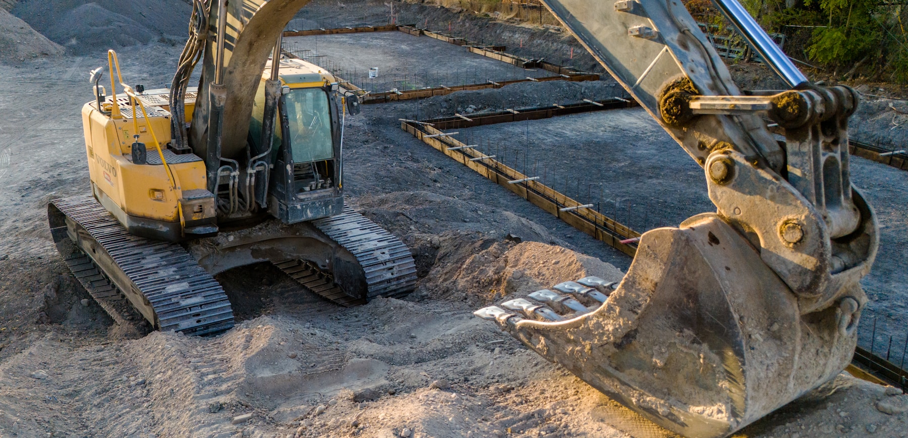 Yellow excavator working on an active construction site